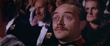 Movie still from “Darling Lili” (1970), directed by Blake Edwards – A man in a military uniform with a mustache; Close Up shot, Low angle