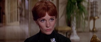 Movie still from “Darling Lili” (1970), directed by Blake Edwards – A person wearing a black shirt; Close Up shot, Over the shoulder angle