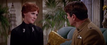 Movie still from “Darling Lili” (1970), directed by Blake Edwards – A woman talking to a man sitting on a couch; Close Up shot, Over the shoulder angle