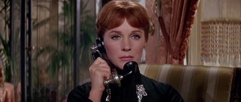 Movie still from “Darling Lili” (1970), directed by Blake Edwards – A woman holding a phone up to her ear; Close Up shot, Low angle