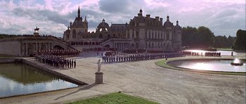 Movie still from “Darling Lili” (1970), directed by Blake Edwards – A large group of people are lined up in front of a building; Extreme Wide shot, High angle
