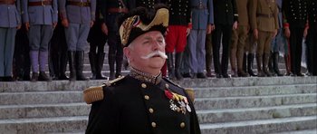 Movie still from “Darling Lili” (1970), directed by Blake Edwards – A man in a military uniform with a mustache; Medium shot, Low angle