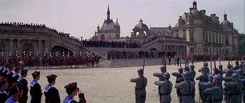 Movie still from “Darling Lili” (1970), directed by Blake Edwards – A group of men in uniform standing in front of a crowd; Extreme Wide shot, High angle