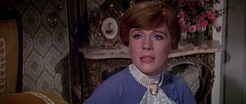 Movie still from “Darling Lili” (1970), directed by Blake Edwards – A person wearing a suit and tie; Close Up shot, Over the shoulder angle