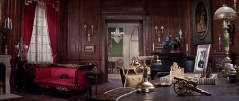 Movie still from “Darling Lili” (1970), directed by Blake Edwards – An old fashioned phone sitting on top of a wooden table; Wide shot, High angle