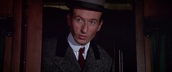Movie still from “Darling Lili” (1970), directed by Blake Edwards – A person wearing a suit and hat; Close Up shot, Low angle