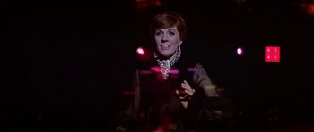 Movie still from “Darling Lili” (1970), directed by Blake Edwards – A woman in a black dress and a diamond necklace; Medium shot, Low angle