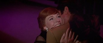 Movie still from “Darling Lili” (1970), directed by Blake Edwards – A man and a woman hugging in a room; Close Up shot, Over the shoulder angle