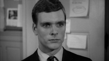 Movie still from “David and Lisa” (1962), directed by Frank Perry – Black and white photograph of a man in a suit; Close Up shot, High angle