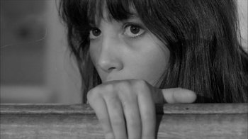 Movie still from “David and Lisa” (1962), directed by Frank Perry – A young girl with her hands over her mouth; Close Up shot, High angle