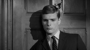 Movie still from “David and Lisa” (1962), directed by Frank Perry – Black and white photograph of a man in a suit; Close Up shot, High angle