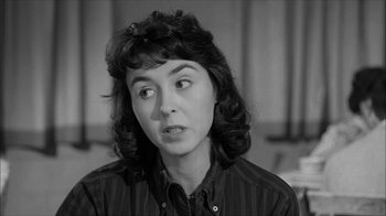 Movie still from “David and Lisa” (1962), directed by Frank Perry – A black - and - white photo of a woman looking at the camera; Close Up shot, Over the shoulder angle