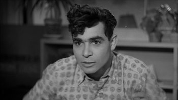 Movie still from “David and Lisa” (1962), directed by Frank Perry – A black and white photo of a man with a mustache; Close Up shot, Over the shoulder angle