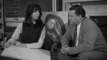 Movie still from “David and Lisa” (1962), directed by Frank Perry – A man and a woman sitting in front of a painting; Medium shot, Over the shoulder angle