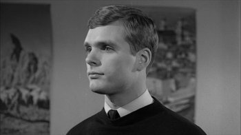 Movie still from “David and Lisa” (1962), directed by Frank Perry – A young man wearing a black sweater and a white tie; Close Up shot, Low angle