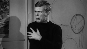 Movie still from “David and Lisa” (1962), directed by Frank Perry – An old photo of a man in a black sweater; Medium shot, Over the shoulder angle