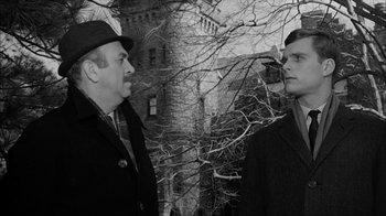 Movie still from “David and Lisa” (1962), directed by Frank Perry – Two men are standing in front of a building; Medium shot, Over the shoulder angle