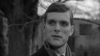 Movie still from “David and Lisa” (1962), directed by Frank Perry – Black and white photograph of a young man in a coat and tie; Close Up shot, Over the shoulder angle