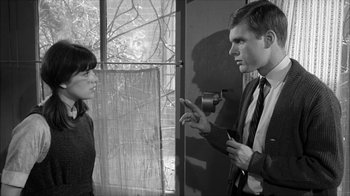Movie still from “David and Lisa” (1962), directed by Frank Perry – A man and a woman talking in front of a window; Medium shot, Over the shoulder angle