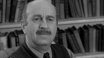 Movie still from “David and Lisa” (1962), directed by Frank Perry – An older man with a beard and a mustache; Close Up shot, Over the shoulder angle