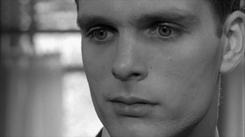 Movie still from “David and Lisa” (1962), directed by Frank Perry – A young man's face in black - and - white; Close Up shot, Over the shoulder angle