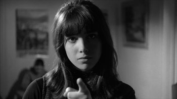 Movie still from “David and Lisa” (1962), directed by Frank Perry – A young woman with bangs is posing for a picture; Close Up shot, Low angle