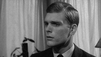 Movie still from “David and Lisa” (1962), directed by Frank Perry – A black and white photo of a man in a suit and tie; Close Up shot, Low angle