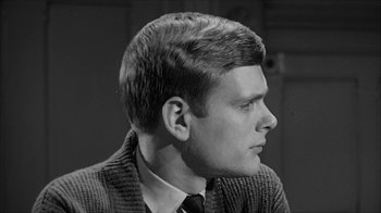 Movie still from “David and Lisa” (1962), directed by Frank Perry – A black and white photo of a man in a suit; Close Up shot, Over the shoulder angle