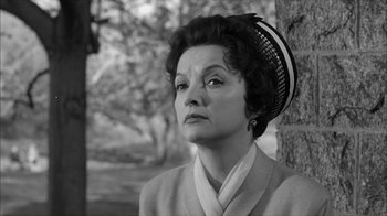 Movie still from “David and Lisa” (1962), directed by Frank Perry – An older woman wearing a hat looking to her left; Close Up shot, Low angle