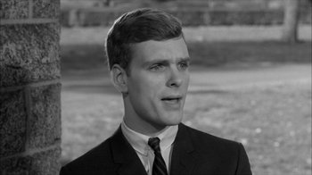Movie still from “David and Lisa” (1962), directed by Frank Perry – A man in a suit and tie looking to his left; Close Up shot, Over the shoulder angle