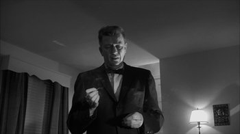 Movie still from “David and Lisa” (1962), directed by Frank Perry – A black and white photo of a man smoking a cigarette; Close Up shot, Low angle