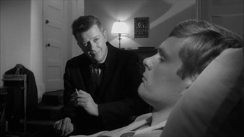 Movie still from “David and Lisa” (1962), directed by Frank Perry – A man in a suit talking to another man in a suit; Close Up shot, Low angle