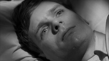 Movie still from “David and Lisa” (1962), directed by Frank Perry – Black and white photograph of a man's face; Close Up shot, Overhead angle