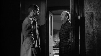 Movie still from “David and Lisa” (1962), directed by Frank Perry – Two men are standing in a doorway and talking to each other; Medium shot, Over the shoulder angle