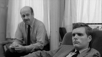 Movie still from “David and Lisa” (1962), directed by Frank Perry – Two men sitting on a couch in front of a window; Medium shot, Over the shoulder angle