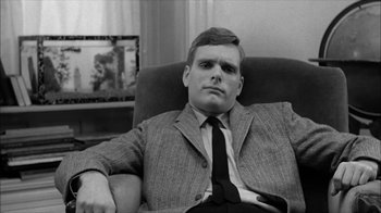 Movie still from “David and Lisa” (1962), directed by Frank Perry – A black and white photo of a man sitting in a chair; Close Up shot, Low angle