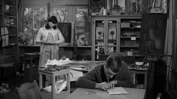 Movie still from “David and Lisa” (1962), directed by Frank Perry – A man and a woman working in an art studio; Medium shot, High angle