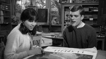Movie still from “David and Lisa” (1962), directed by Frank Perry – A man and a woman sitting at a table; Medium shot, High angle