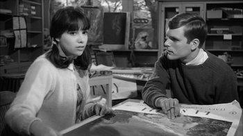 Movie still from “David and Lisa” (1962), directed by Frank Perry – A man and a woman sitting at a table; Medium shot, High angle