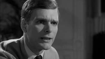Movie still from “David and Lisa” (1962), directed by Frank Perry – Black and white photograph of a man in a suit; Close Up shot, Over the shoulder angle