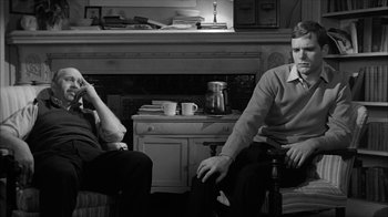 Movie still from “David and Lisa” (1962), directed by Frank Perry – Two people sitting in front of a fire place; Medium shot, Over the shoulder angle