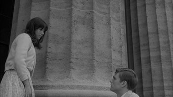 Movie still from “David and Lisa” (1962), directed by Frank Perry – A man and a woman looking at each other in front of a building; Medium shot, High angle