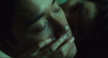 Movie still from “Days of Being Wild” (1990), directed by Kar-Wai Wong – A person with their hands over their mouth; Extreme Close Up shot, Over the shoulder angle