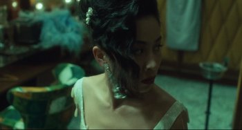 Movie still from “Days of Being Wild” (1990), directed by Kar-Wai Wong – A person wearing a dress; Close Up shot, Over the shoulder angle