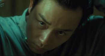 Movie still from “Days of Being Wild” (1990), directed by Kar-Wai Wong – A man's eyes and face; Close Up shot, Low angle