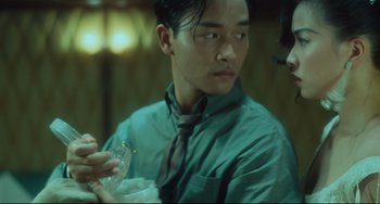 Movie still from “Days of Being Wild” (1990), directed by Kar-Wai Wong – A man in a green dress shirt and a tie; Close Up shot, Low angle