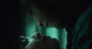 Movie still from “Days of Being Wild” (1990), directed by Kar-Wai Wong – A man and a woman kissing in a room lit by a green light; Extreme Close Up shot, Overhead angle
