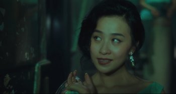 Movie still from “Days of Being Wild” (1990), directed by Kar-Wai Wong – A beautiful young lady holding a bottle in her hand; Close Up shot, Over the shoulder angle