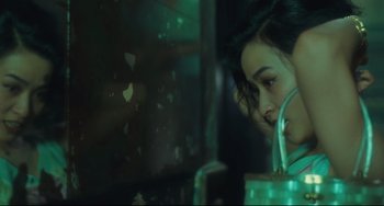 Movie still from “Days of Being Wild” (1990), directed by Kar-Wai Wong – A woman is looking out of a window at night; Close Up shot, Over the shoulder angle