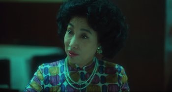Movie still from “Days of Being Wild” (1990), directed by Kar-Wai Wong – An older woman wearing a colorful dress and pearls; Close Up shot, Low angle